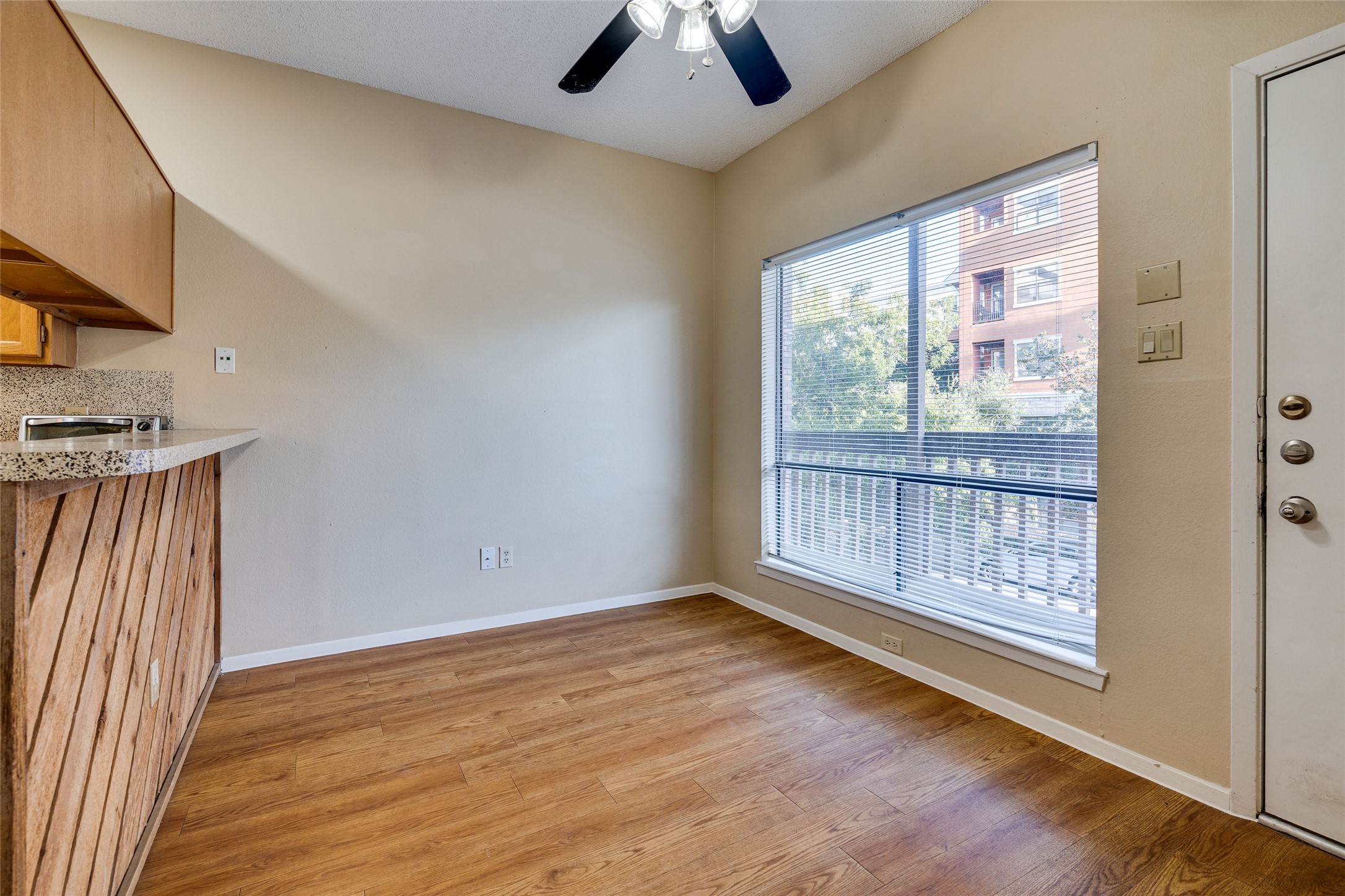 2210 Pearl Street, Unit 203 Austin, TX 78705 - Photo 8 of 22 a view of an empty room with window and wooden floor