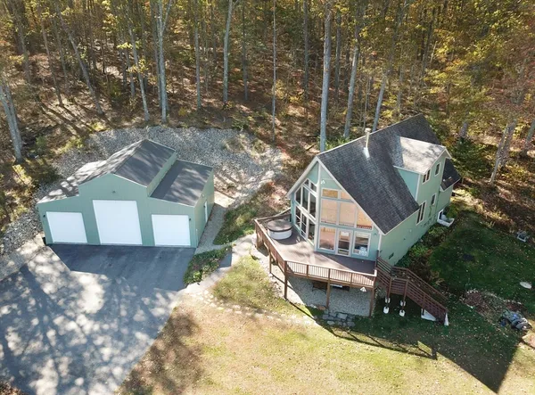 an aerial view of a house with a yard