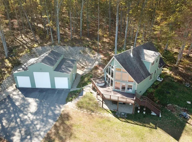 an aerial view of a house with a yard
