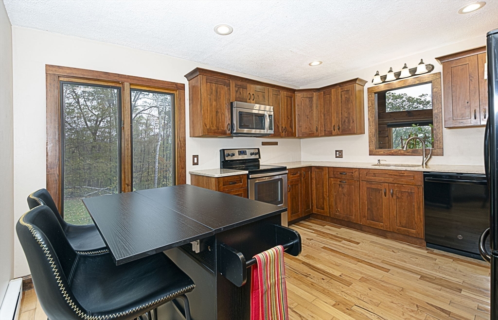 17 West Shore Drive Ashburnham, MA 01430 - Photo 12 of 42 a kitchen with a table chairs microwave and window