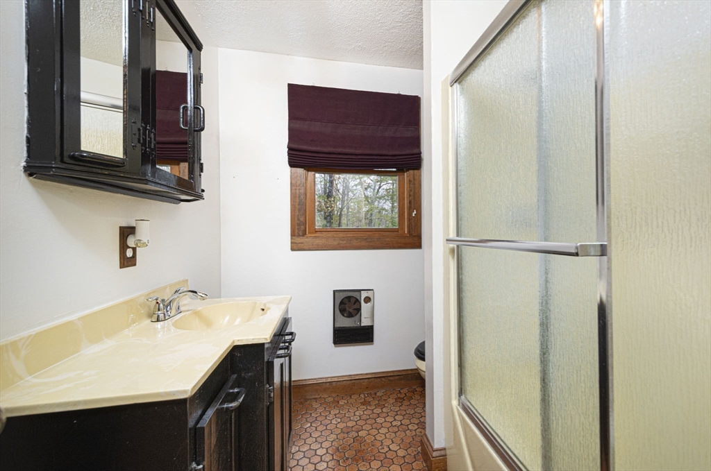 17 West Shore Drive Ashburnham, MA 01430 - Photo 13 of 42 a bathroom with a sink a mirror and a shower