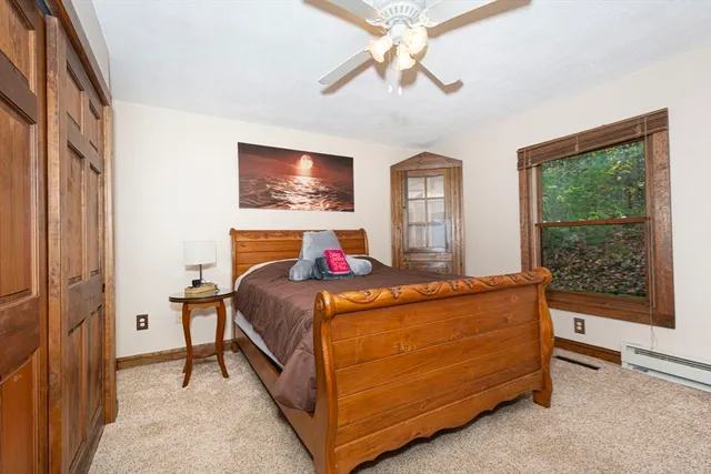 a bedroom with a bed and window