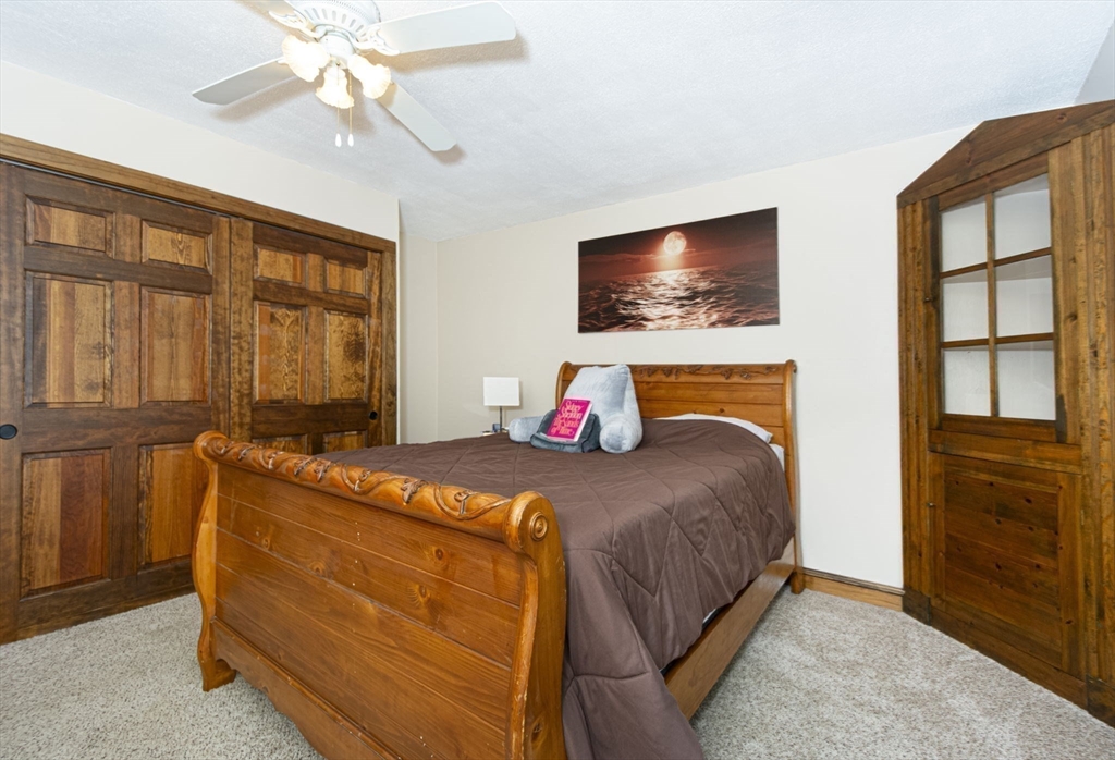 17 West Shore Drive Ashburnham, MA 01430 - Photo 16 of 42 a bedroom with a bed and a flat screen tv