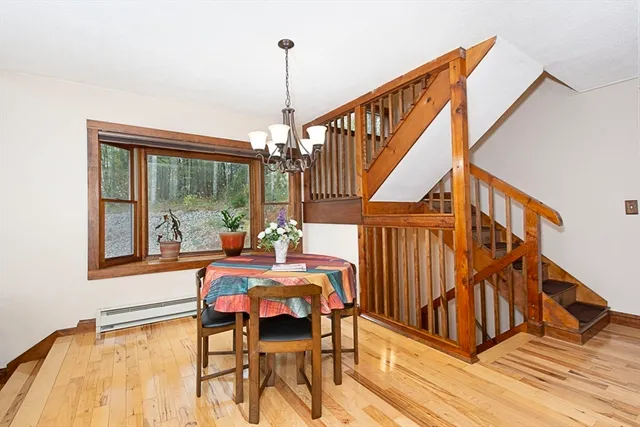 a view of entryway dining room and hall with wooden floor