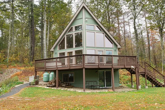 a view of a house with backyard porch and sitting area