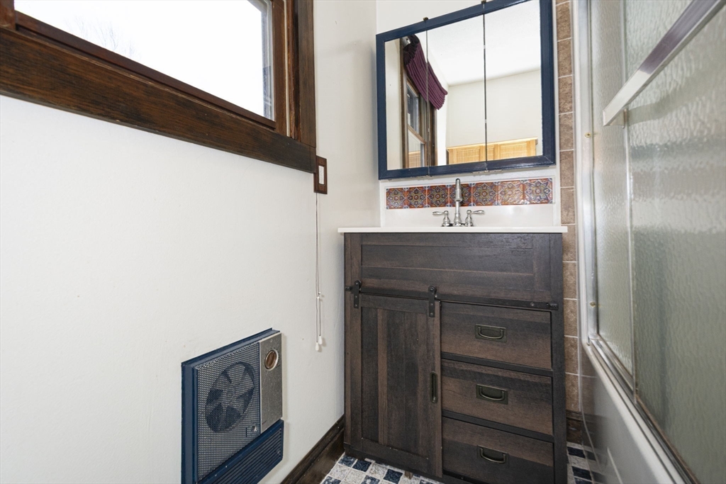 17 West Shore Drive Ashburnham, MA 01430 - Photo 22 of 42 a bathroom with a sink a mirror and a window