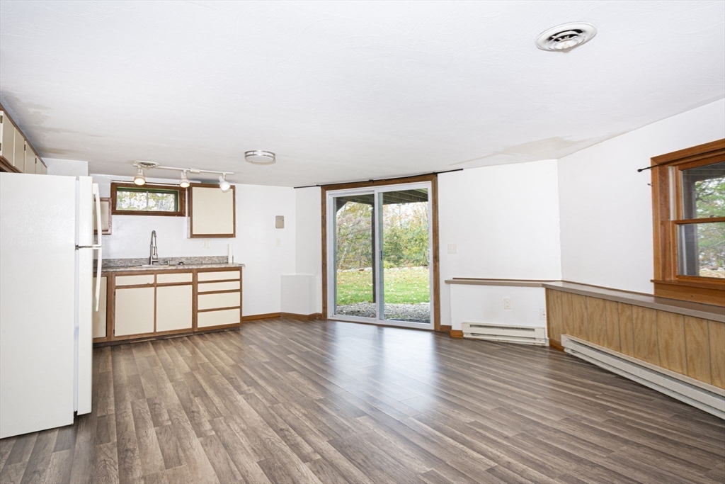 17 West Shore Drive Ashburnham, MA 01430 - Photo 23 of 42 a kitchen with stainless steel appliances wooden floors and white walls