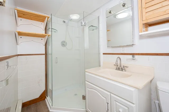 a bathroom with a sink a mirror and a shower