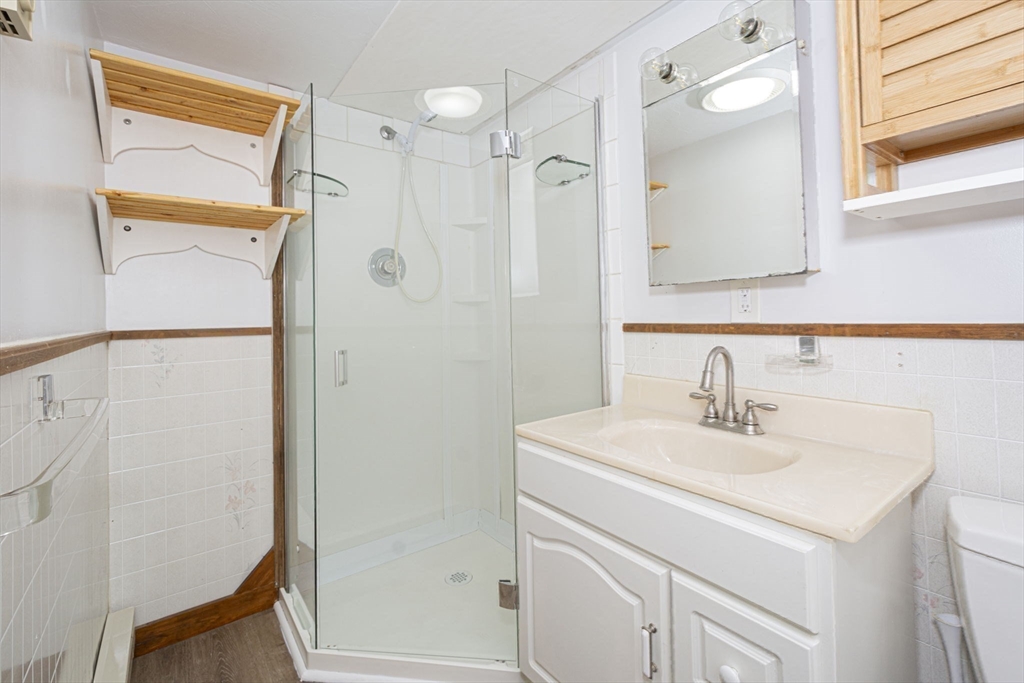 17 West Shore Drive Ashburnham, MA 01430 - Photo 27 of 42 a bathroom with a sink a mirror and a shower