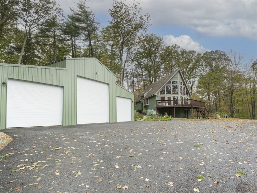 17 West Shore Drive Ashburnham, MA 01430 - Photo 3 of 42 a front view of a house with a yard and garage