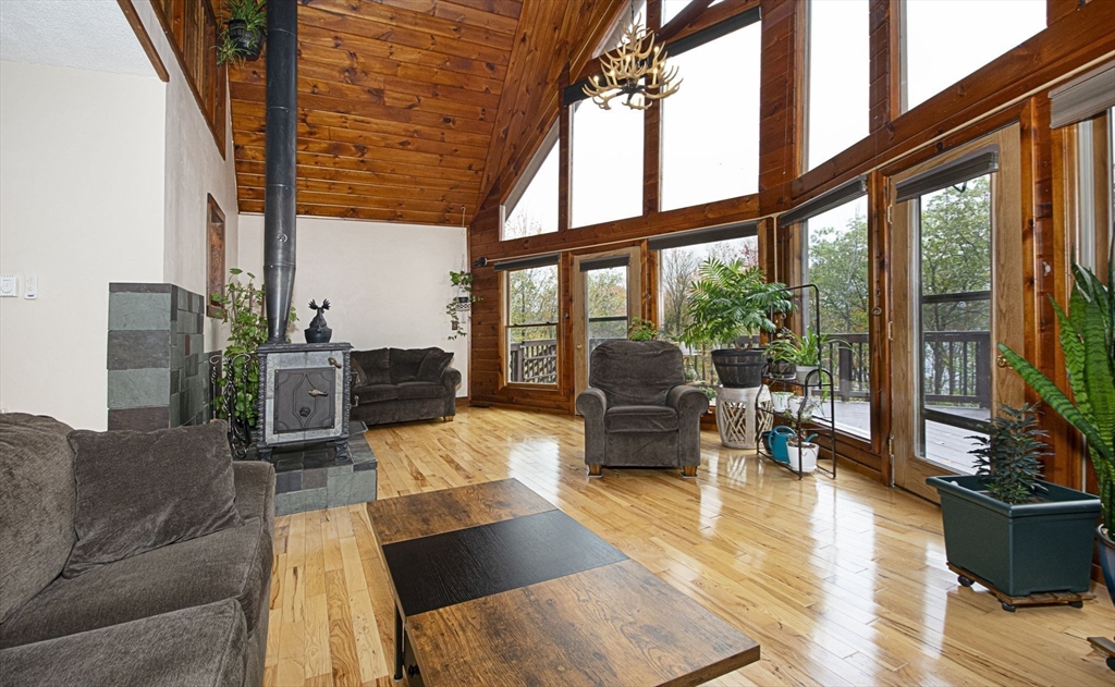 17 West Shore Drive Ashburnham, MA 01430 - Photo 6 of 42 a living room with furniture and a floor to ceiling window