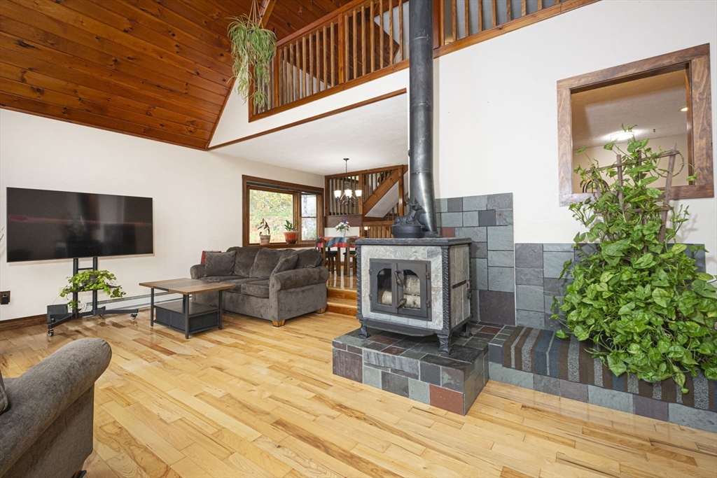 17 West Shore Drive Ashburnham, MA 01430 - Photo 9 of 42 a living room with furniture a fireplace and a flat screen tv