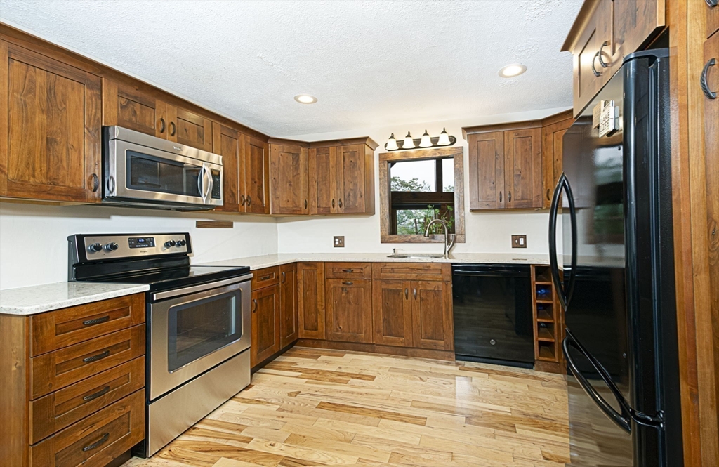 17 West Shore Drive Ashburnham, MA 01430 - Photo 10 of 42 a kitchen with stainless steel appliances granite countertop a stove a sink and a microwave