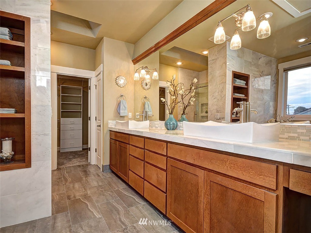 906 North 27th Place Renton, WA 98056 - Photo 12 of 25 a bathroom with a sink vanity and a mirror