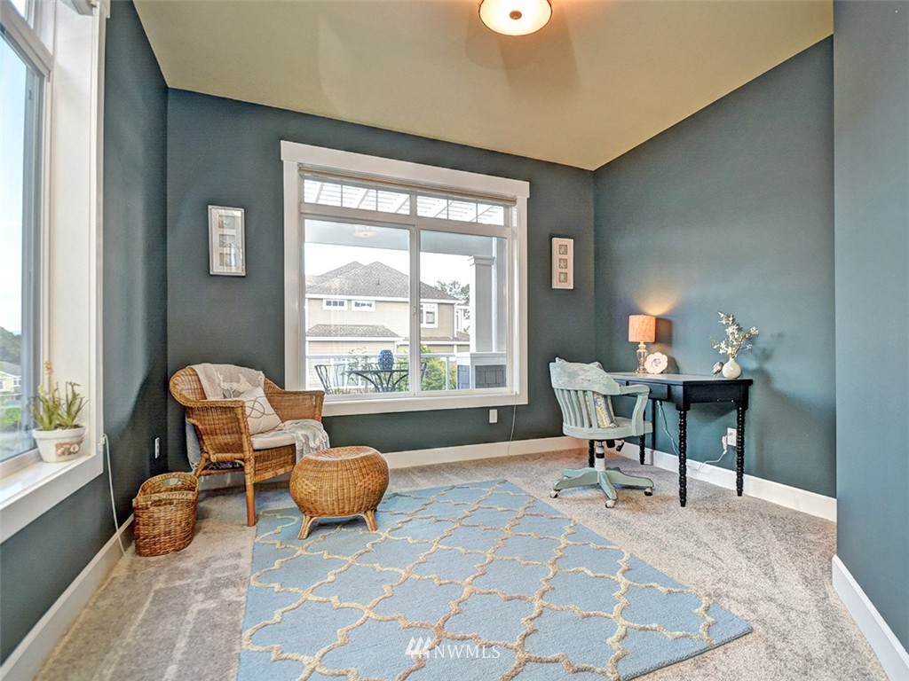 906 North 27th Place Renton, WA 98056 - Photo 13 of 25 a living room with furniture and a floor to ceiling window