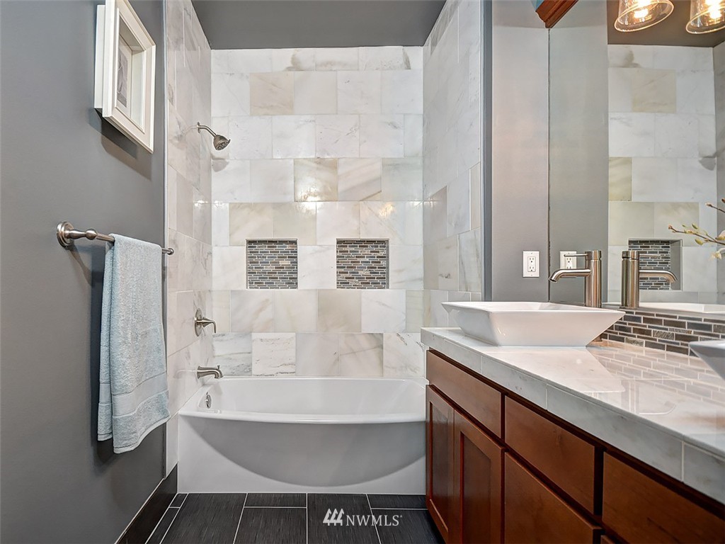 906 North 27th Place Renton, WA 98056 - Photo 14 of 25 a bathroom with a sink and a bathtub