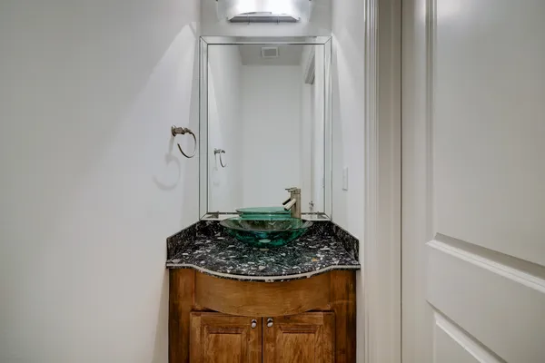 a bathroom with a granite countertop sink and vanity