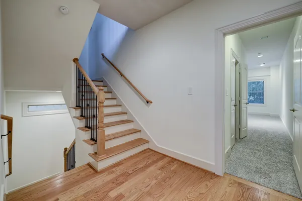 a view of entryway and hall with wooden floor
