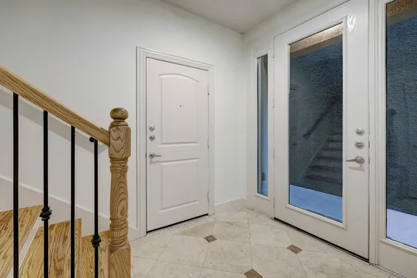 a view of a hallway with wooden floor and entryway