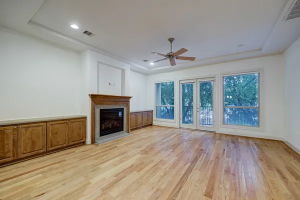 a view of an empty room with a fireplace and a window