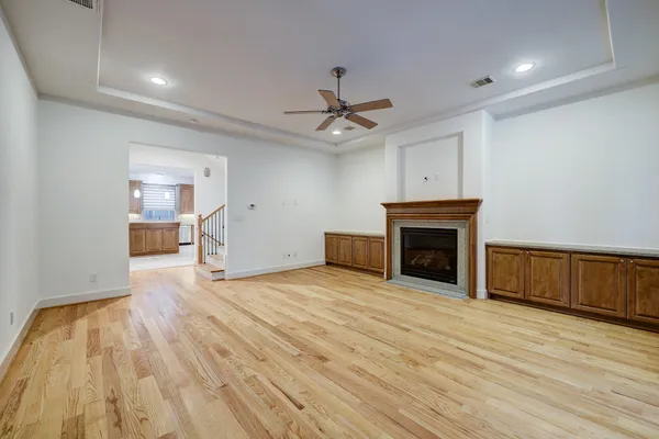 a view of empty room with wooden floor and fireplace