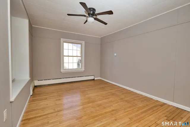 wooden floor in an empty room with a window