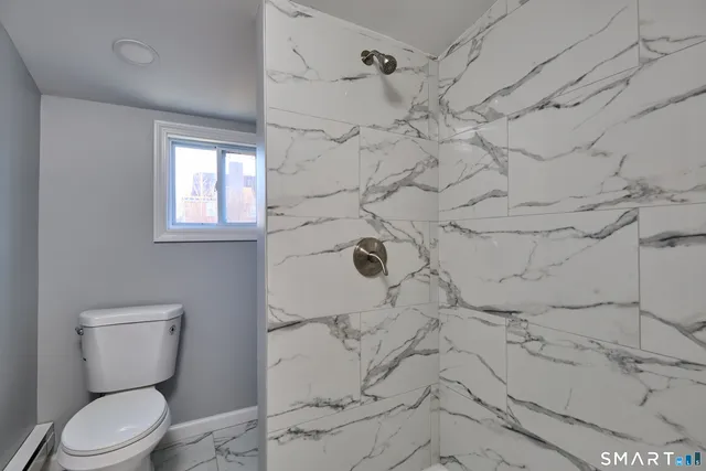 a bathroom with a toilet and shower