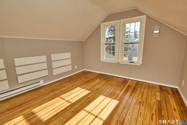 a view of wooden floor and windows in a room