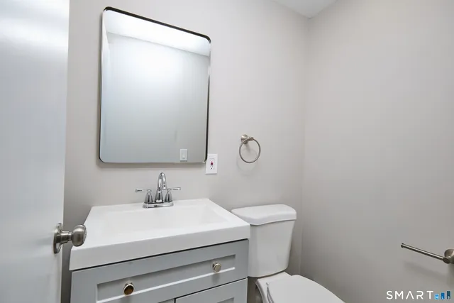 a white toilet sitting next to a bathroom sink