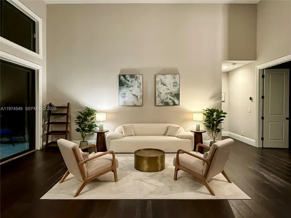 a view of a livingroom with furniture wooden floor and window