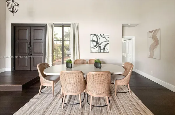 a kitchen with stainless steel appliances a refrigerator a stove a sink and white cabinets with wooden floor