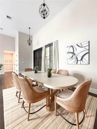 a large kitchen with a large counter top space a sink stainless steel appliances and cabinets