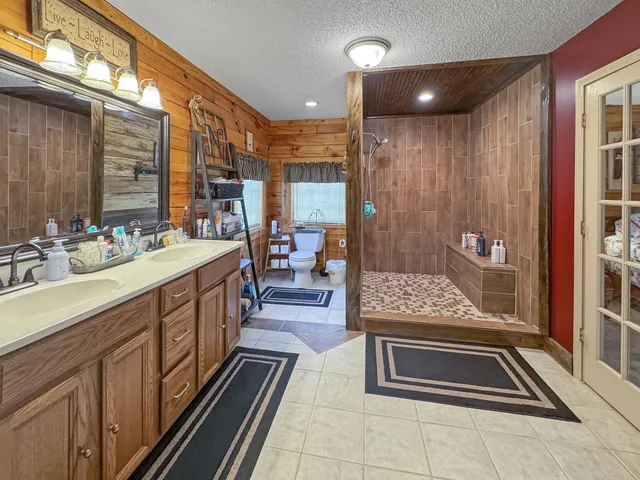 a bathroom with a sink mirror and a shower
