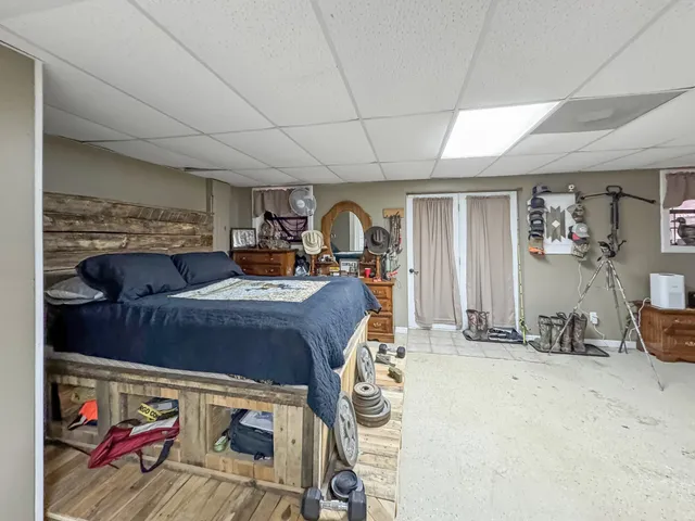 a bed room with a bed mirror and a desk