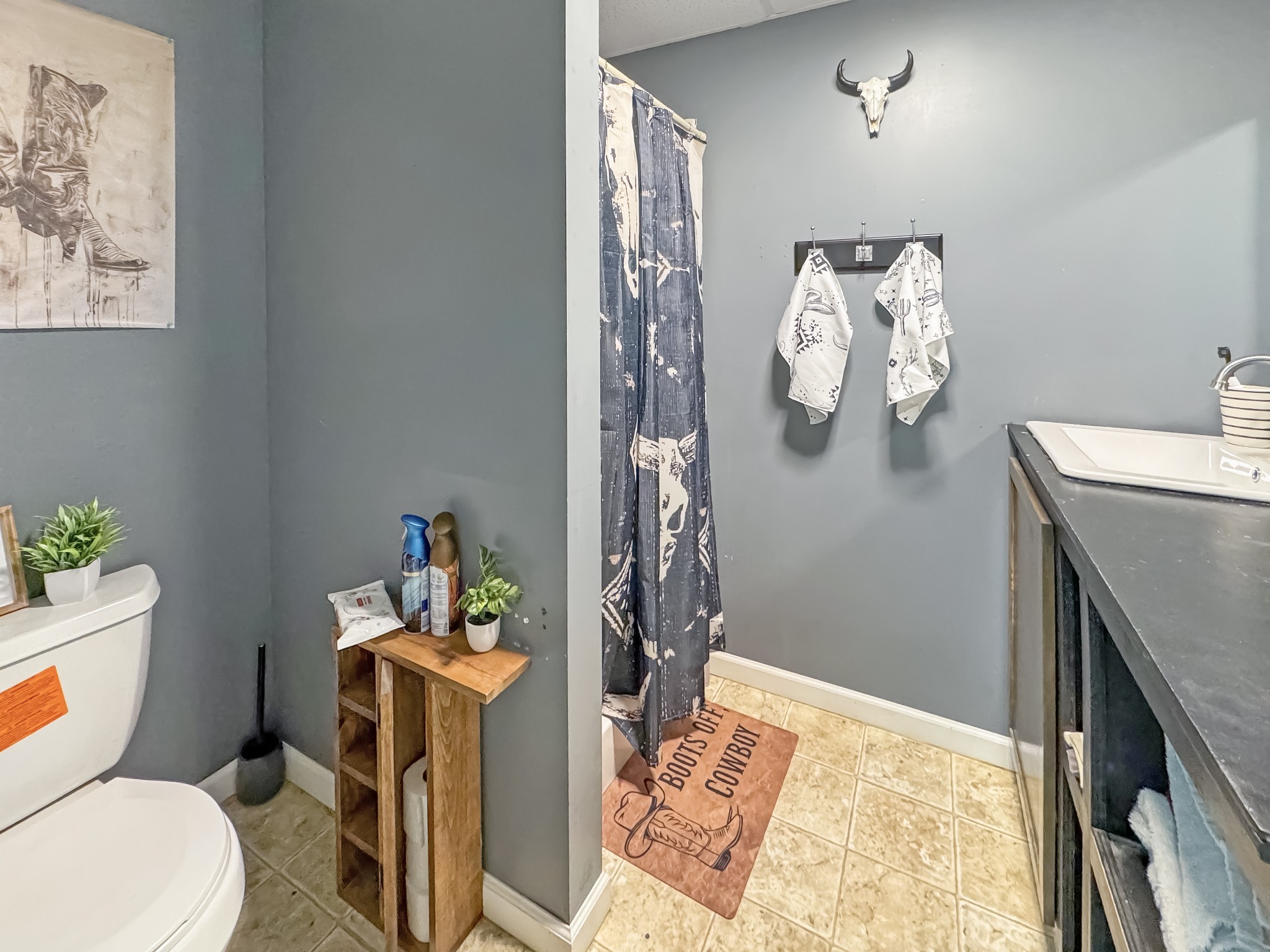 130 Wayne Threatt Road Dover, TN 37058 - Photo 18 of 28 a bathroom with a granite countertop sink a toilet and a shower