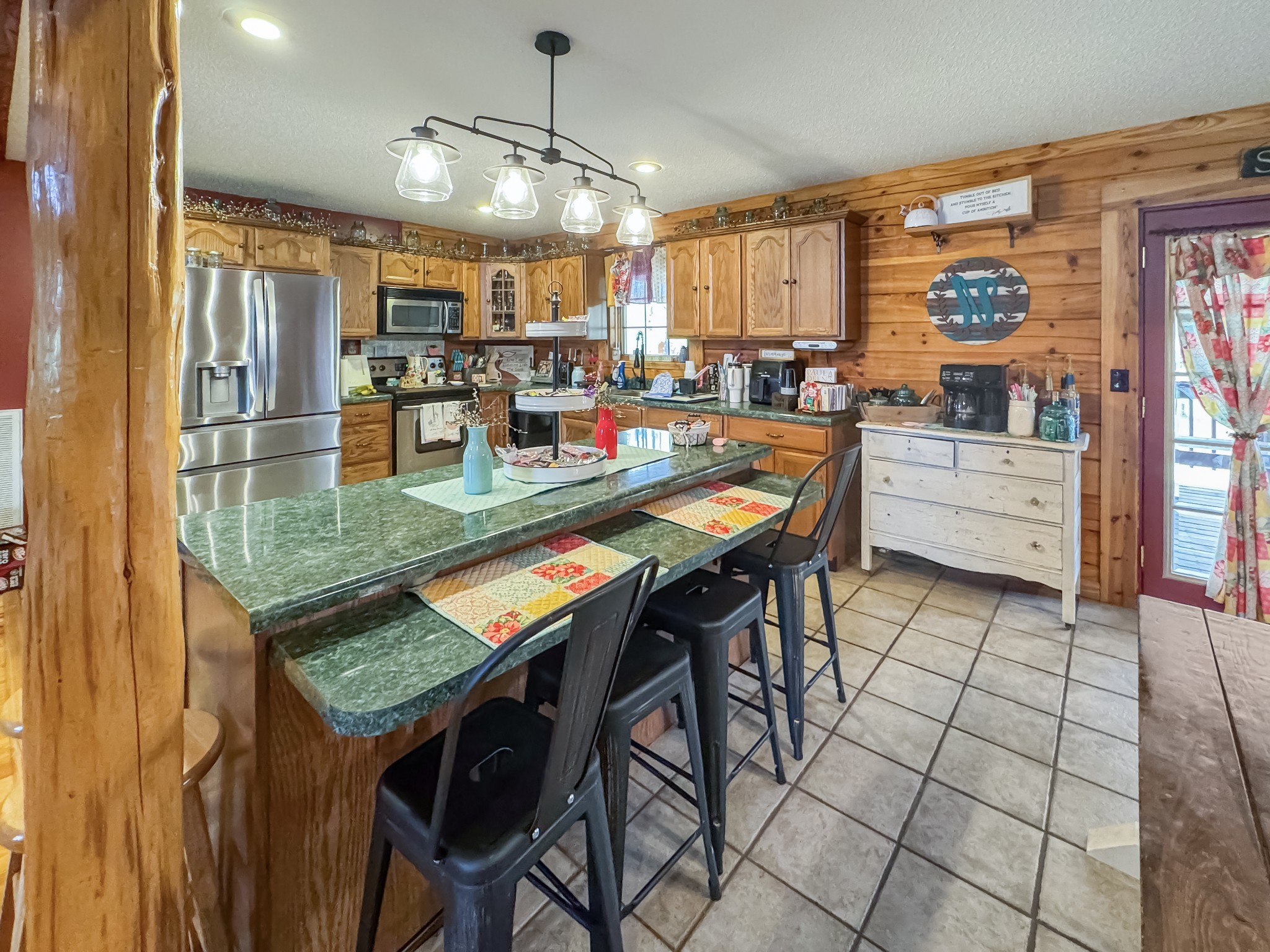 130 Wayne Threatt Road Dover, TN 37058 - Photo 10 of 28 a kitchen with stainless steel appliances granite countertop table chairs microwave and cabinets