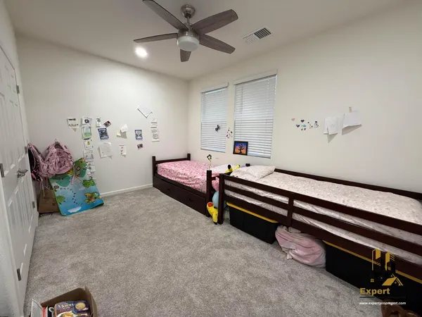 a bedroom with furniture and a ceiling fan