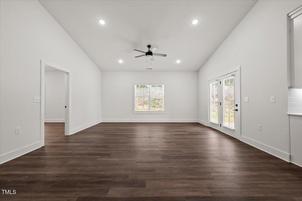130 Old Heritage Road Randleman, NC 27317 - Photo 11 of 24 an empty room with wooden floor chandelier and windows