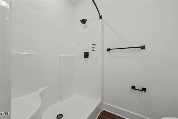 a bathroom with a double vanity sink and mirror with toilet