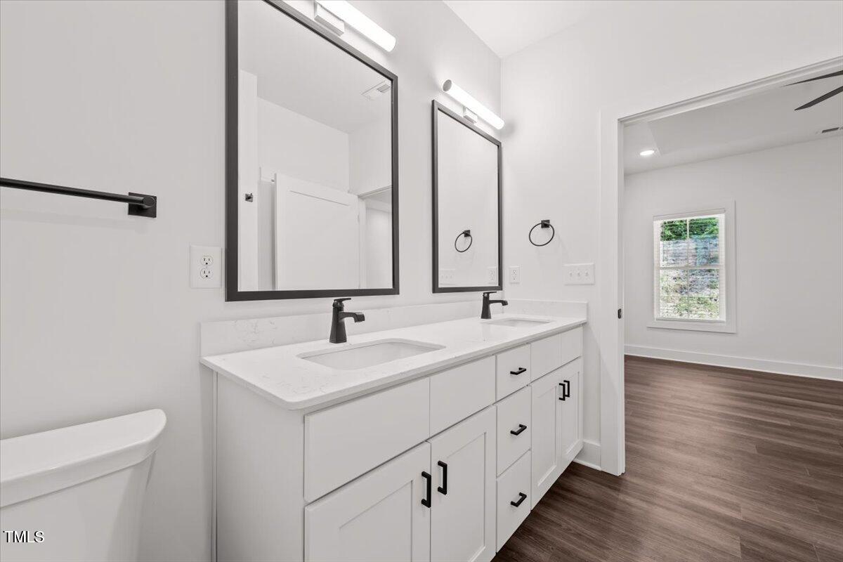 130 Old Heritage Road Randleman, NC 27317 - Photo 14 of 24 a bathroom with a double vanity sink and mirror with toilet