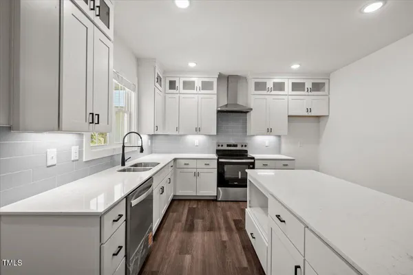 a kitchen with a sink stove and cabinets