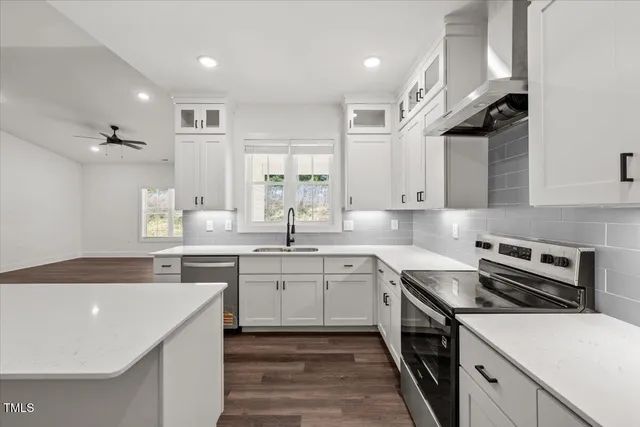 a kitchen with a sink stainless steel appliances and cabinets