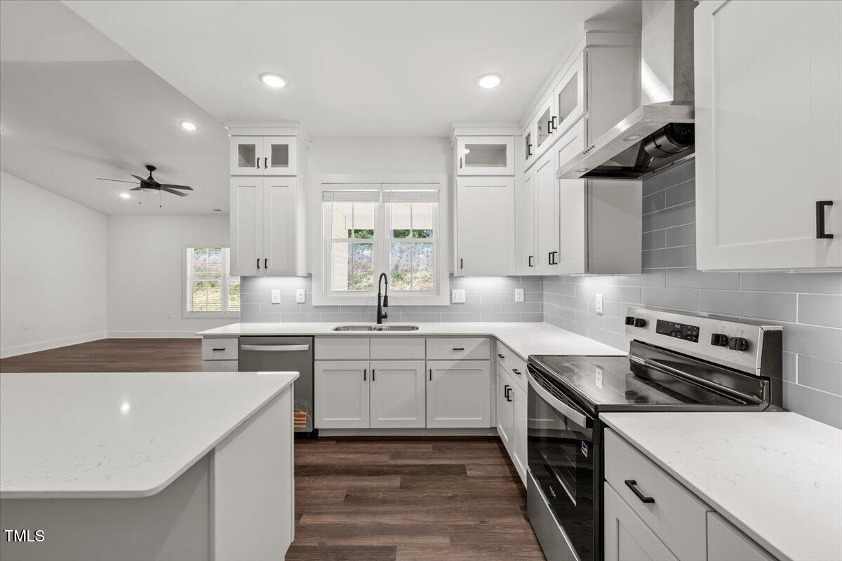130 Old Heritage Road Randleman, NC 27317 - Photo 5 of 24 a kitchen with a sink stainless steel appliances and cabinets