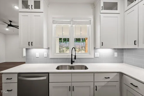a kitchen with a sink and cabinets