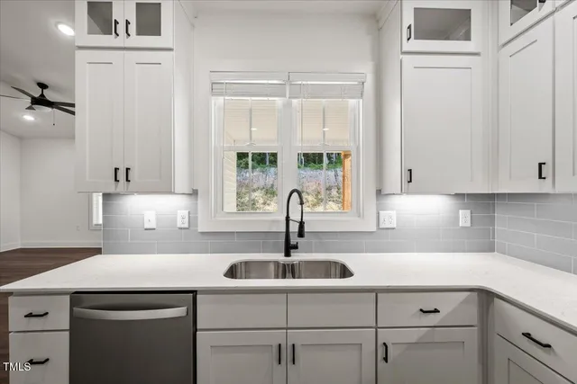 a kitchen with a sink and cabinets