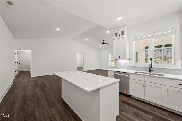 a view of kitchen with windows and refrigerator