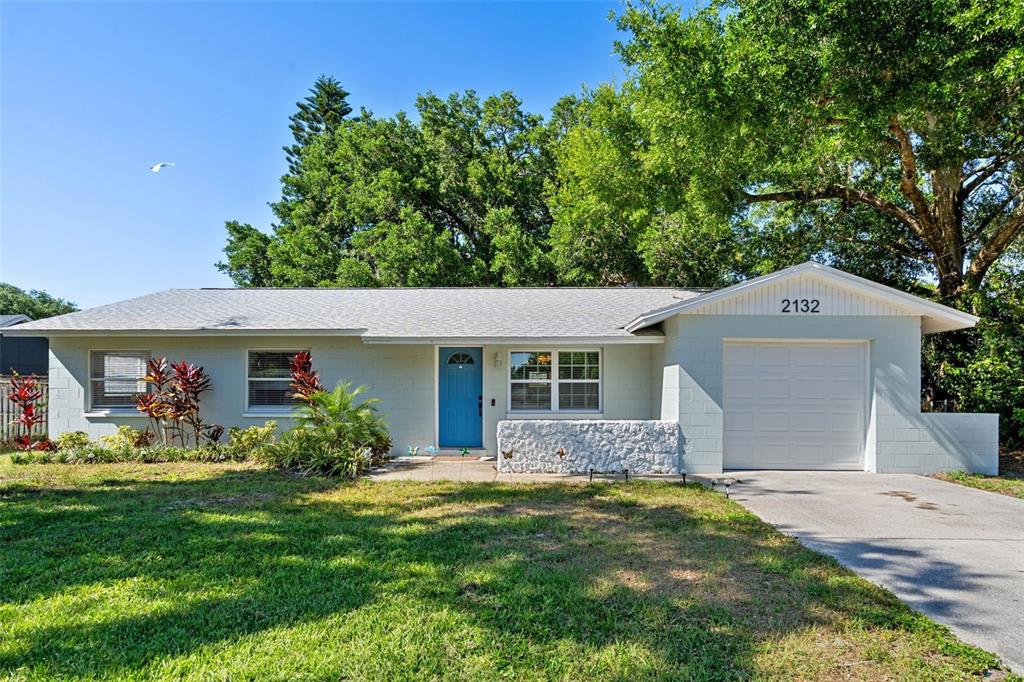 2132 Rouse Lake Road Orlando, FL 32817 - Photo 1 of 1 a front view of house with yard and trees in the background