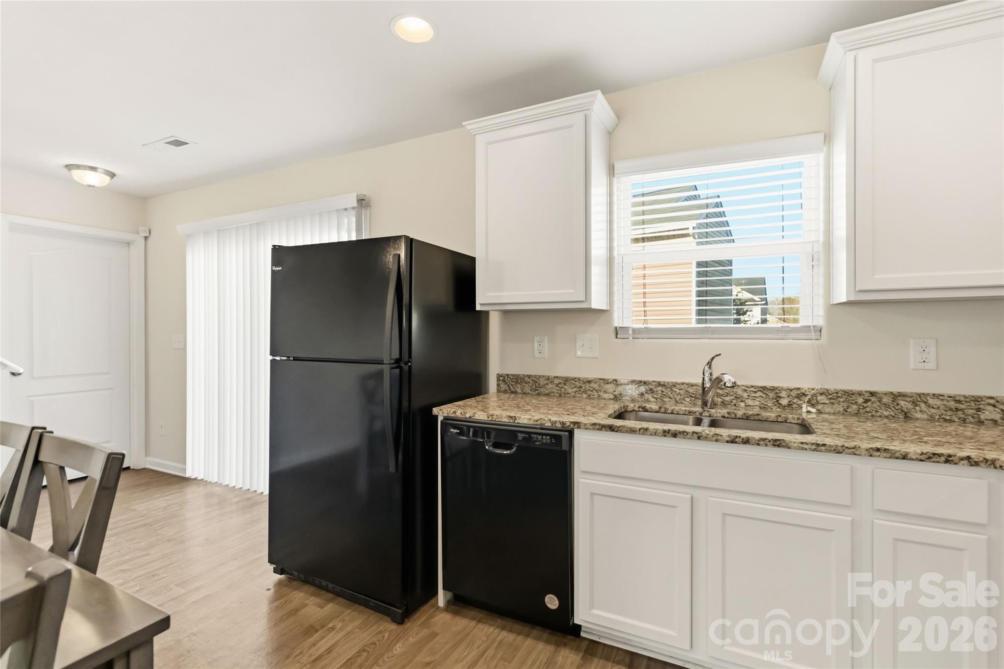 14015 Rory Glen Lane Charlotte, NC 28215 - Photo 13 of 28 a kitchen with a refrigerator sink and cabinets