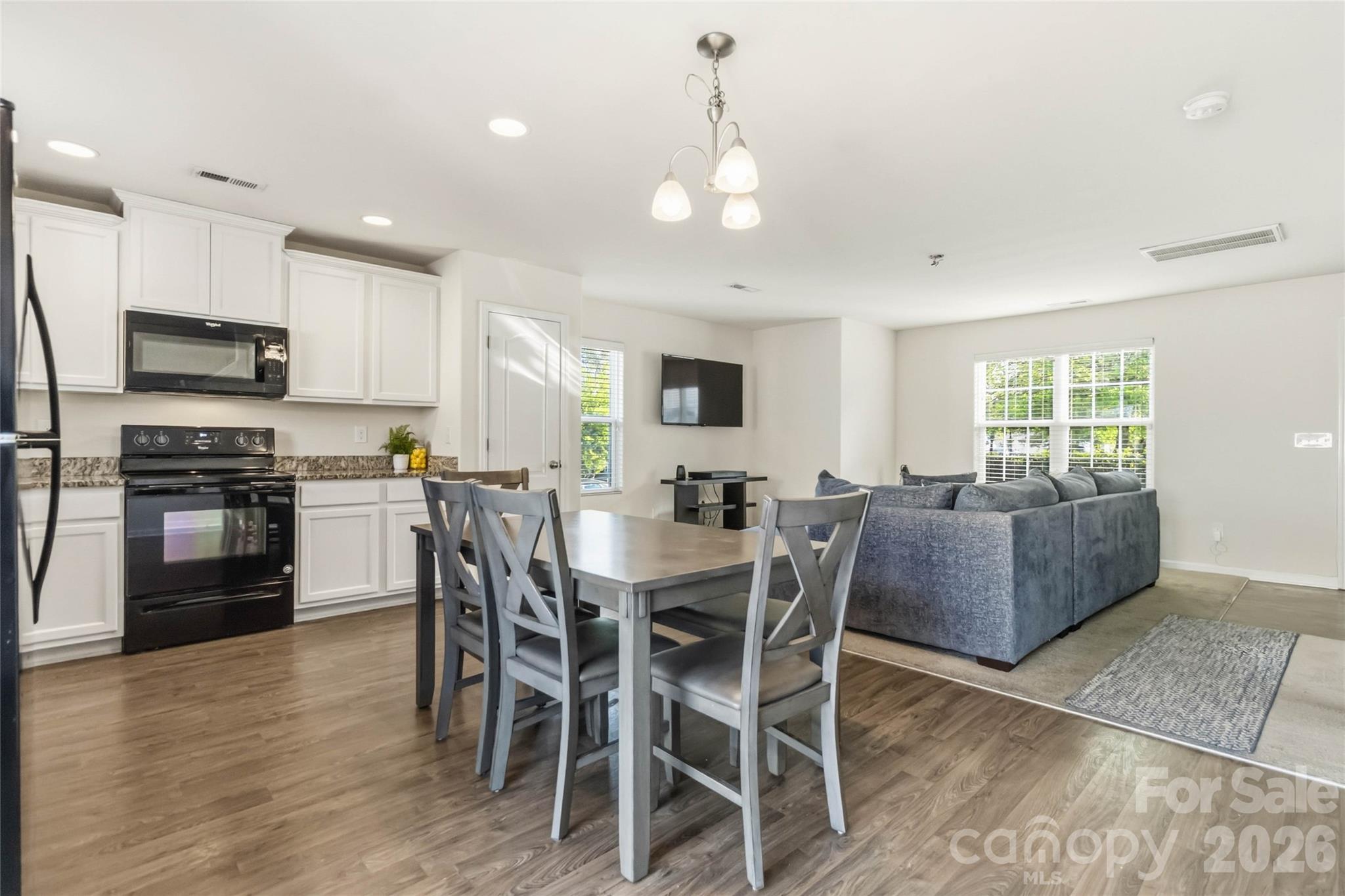 14015 Rory Glen Lane Charlotte, NC 28215 - Photo 15 of 28 a view of kitchen with refrigerator a stove a dining table and chairs