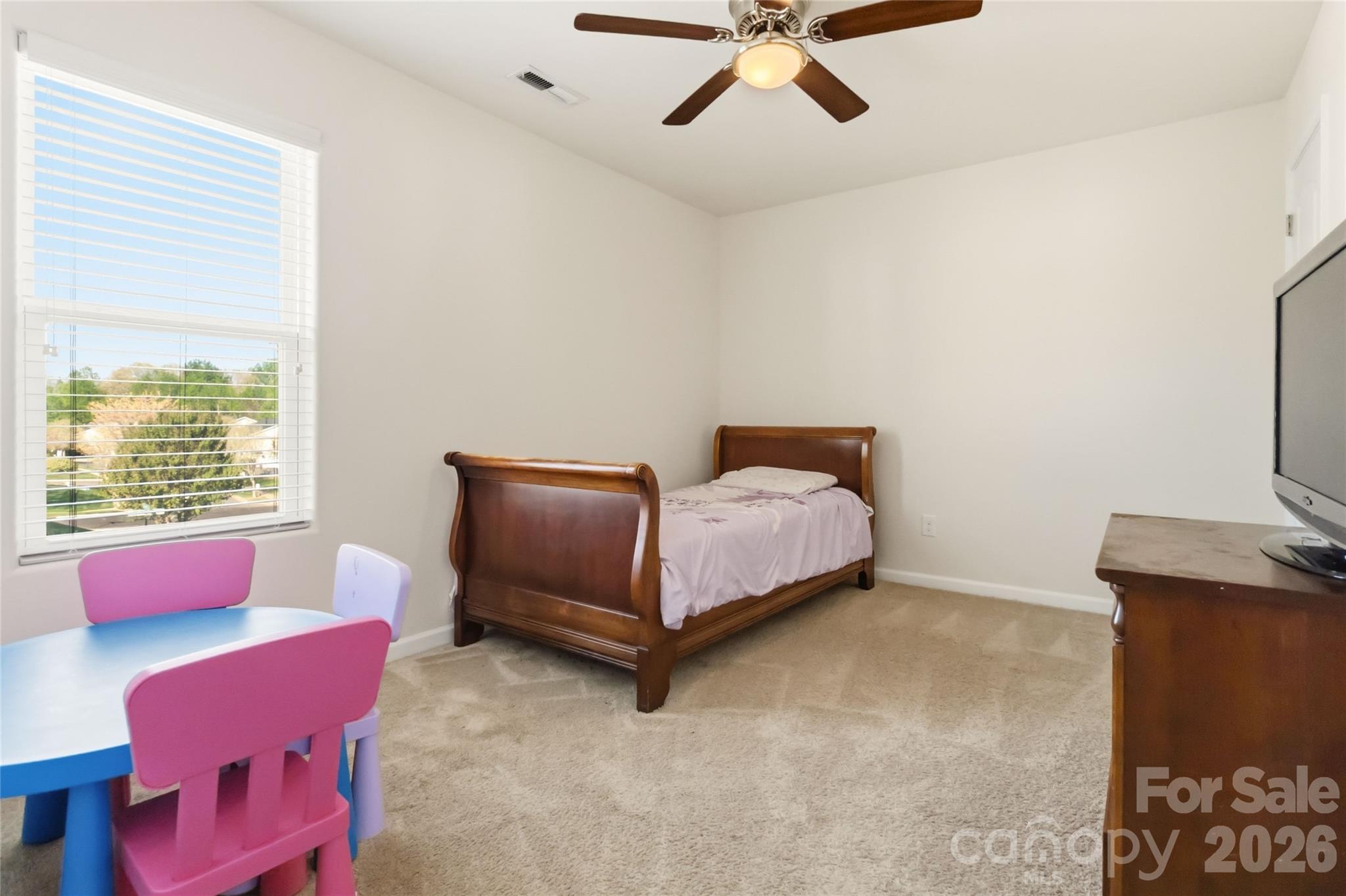 14015 Rory Glen Lane Charlotte, NC 28215 - Photo 20 of 28 a bedroom with a bed and a chandelier